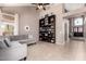 A living room features a gray sofa, neutral walls, and a large bookshelf at 1521 W Kent Dr, Chandler, AZ 85224