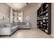 A living room featuring a gray sofa, neutral walls, and a large bookshelf at 1521 W Kent Dr, Chandler, AZ 85224