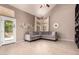 A living room features a gray sofa, neutral walls, tile floors, and access to the patio at 1521 W Kent Dr, Chandler, AZ 85224
