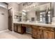 Main bathroom featuring double sink vanity, ample cabinet space, and large framed mirror at 1521 W Kent Dr, Chandler, AZ 85224