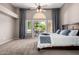 Bright main bedroom with ceiling fan and sliding glass doors leading to outdoor patio at 1521 W Kent Dr, Chandler, AZ 85224