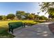 Park view with benches along a walking path in a lush green community area at 1521 W Kent Dr, Chandler, AZ 85224