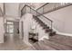 Elegant staircase features carpeted steps and sleek iron railings in a spacious foyer at 1521 W Kent Dr, Chandler, AZ 85224