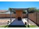 Relaxing backyard with shaded pergola, patio, and a small potted plant, perfect for outdoor living at 15537 W Port Royale Ln, Surprise, AZ 85379