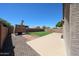 A large, well maintained backyard features a grass lawn, and a stone patio area at 15537 W Port Royale Ln, Surprise, AZ 85379