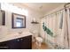 Bathroom featuring modern vanity and a shower with a colorful peacock shower curtain at 15537 W Port Royale Ln, Surprise, AZ 85379