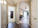Hallway with arched doorways offering a seamless transition between rooms and a glimpse into the home's open layout at 15537 W Port Royale Ln, Surprise, AZ 85379