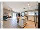 Open-concept kitchen boasts ample counter space, a breakfast bar, and seamless flow into the living area at 15537 W Port Royale Ln, Surprise, AZ 85379