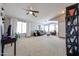 Inviting living room with plush carpeting, neutral paint, and a seating area with a sofa, recliner, and ottoman at 15537 W Port Royale Ln, Surprise, AZ 85379