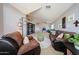 Inviting living room with plush carpeting, neutral paint, and a comfortable seating area, arched doorway, and ceiling fan at 15537 W Port Royale Ln, Surprise, AZ 85379