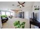 Bright and airy living room boasts neutral paint, plush carpeting, and abundant natural light from large windows at 15537 W Port Royale Ln, Surprise, AZ 85379