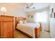 Well lit main bedroom featuring ceiling fan, neutral carpet and a wooden furniture set at 15537 W Port Royale Ln, Surprise, AZ 85379
