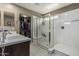Bright bathroom featuring a double sink vanity and a glass enclosed shower with a built-in seat at 1723 N Hillcrest --, Mesa, AZ 85201