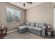 Cozy bedroom featuring a gray sectional sofa and a bright window at 1723 N Hillcrest --, Mesa, AZ 85201