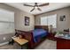 Bedroom features a ceiling fan, window with blinds, carpeted floors, desk, and a bed at 1723 N Hillcrest --, Mesa, AZ 85201