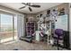 Bedroom featuring a ceiling fan, carpeted floors, desk, shelves, and access to the balcony at 1723 N Hillcrest --, Mesa, AZ 85201