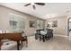 Bright dining room with elegant tile flooring, ceiling fan, and a formal dining table for eight guests at 1723 N Hillcrest --, Mesa, AZ 85201