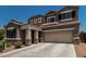 Inviting two-story home showcasing a spacious two-car garage and manicured front yard landscape under a clear, blue sky at 1723 N Hillcrest --, Mesa, AZ 85201