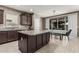 Modern kitchen with granite countertops, dark wood cabinets, and a breakfast bar island looking into the dining area at 1723 N Hillcrest --, Mesa, AZ 85201