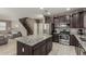 This is a kitchen with a large center island, stainless steel appliances, and views of the stairs and Gathering room at 1723 N Hillcrest --, Mesa, AZ 85201