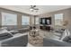 Inviting living room with plush gray sofas, a ceiling fan, and a large television for entertainment at 1723 N Hillcrest --, Mesa, AZ 85201