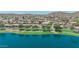 Serene lake community with green park spaces surrounded by homes, and mountain views at 18088 W San Alejandro Dr, Goodyear, AZ 85338