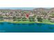 Expansive lakefront property showcasing lush green spaces, mature trees, and serene water views at 18088 W San Alejandro Dr, Goodyear, AZ 85338
