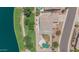 An aerial view of the house with a pool, covered patio, desert landscaping, and lake access at 18088 W San Alejandro Dr, Goodyear, AZ 85338
