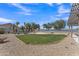 Expansive backyard with lush grass, desert landscaping, and lake views for relaxing and entertaining at 18088 W San Alejandro Dr, Goodyear, AZ 85338