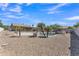 Resort-style backyard features a private pool, rock waterfall, and covered patio for relaxing and entertaining at 18088 W San Alejandro Dr, Goodyear, AZ 85338