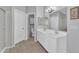 Bathroom featuring a double sink vanity and a separate toilet room, all with neutral tile floors at 18088 W San Alejandro Dr, Goodyear, AZ 85338