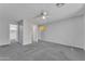 Large bedroom with gray carpeted floor. The picture shows doorways into closet and bathroom at 18088 W San Alejandro Dr, Goodyear, AZ 85338