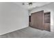 Bedroom featuring a built-in Murphy bed and shelving unit, paired with gray carpeted floors at 18088 W San Alejandro Dr, Goodyear, AZ 85338
