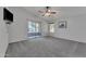 Spacious bedroom with ceiling fan, carpet and sliding door leading to patio at 18088 W San Alejandro Dr, Goodyear, AZ 85338