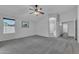 Bedroom with carpet, ceiling fan, and access to ensuite bathroom at 18088 W San Alejandro Dr, Goodyear, AZ 85338