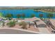 Beautiful lakefront home featuring a backyard pool and a covered patio, perfect for outdoor entertaining at 18088 W San Alejandro Dr, Goodyear, AZ 85338