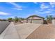Charming single-story home with a three-car garage, desert landscaping, and neutral color palette at 18088 W San Alejandro Dr, Goodyear, AZ 85338