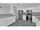 Kitchen with stainless steel appliances, white cabinets, and tiled countertops at 18088 W San Alejandro Dr, Goodyear, AZ 85338