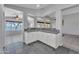 Kitchen with white cabinets, grey tile floor, and view of lake from windows at 18088 W San Alejandro Dr, Goodyear, AZ 85338
