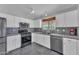 Kitchen with stainless steel appliances, white cabinets, and modern fixtures at 18088 W San Alejandro Dr, Goodyear, AZ 85338