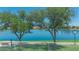 Scenic lake views featuring large shade trees, grassy areas, and walking paths for resident enjoyment at 18088 W San Alejandro Dr, Goodyear, AZ 85338