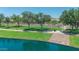 Scenic lake park features lush lawns, walking paths, and views of residential homes at 18088 W San Alejandro Dr, Goodyear, AZ 85338