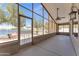A relaxing patio with a dining table, seating, lighting, a ceiling fan, and scenic lake views. For Rent sign visible at 18088 W San Alejandro Dr, Goodyear, AZ 85338