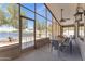 A relaxing patio with a dining table, seating, lighting, a ceiling fan, and scenic lake views at 18088 W San Alejandro Dr, Goodyear, AZ 85338