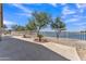 Outdoor patio with a scenic lake view and mature shade trees offering a serene outdoor living space at 18088 W San Alejandro Dr, Goodyear, AZ 85338