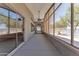 Spacious screened in patio with ceiling fans, tile floors, and outdoor lighting with access to lake views at 18088 W San Alejandro Dr, Goodyear, AZ 85338