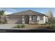 Charming single-story home featuring a neutral color palette, landscaped front yard, and a two-car garage at 1859 S 181St Dr, Goodyear, AZ 85338