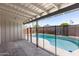 Covered back patio next to a fenced pool with a patio and concrete flooring at 1911 E Lawrence Rd, Phoenix, AZ 85016
