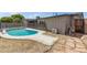 View of the pool and backyard, with stone pavers and mature trees at 1911 E Lawrence Rd, Phoenix, AZ 85016
