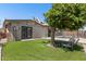 Landscaped backyard with artificial turf, shade tree and access to the fenced pool at 1911 E Lawrence Rd, Phoenix, AZ 85016